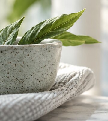 Leaf detail in a softly lit ceramic pot